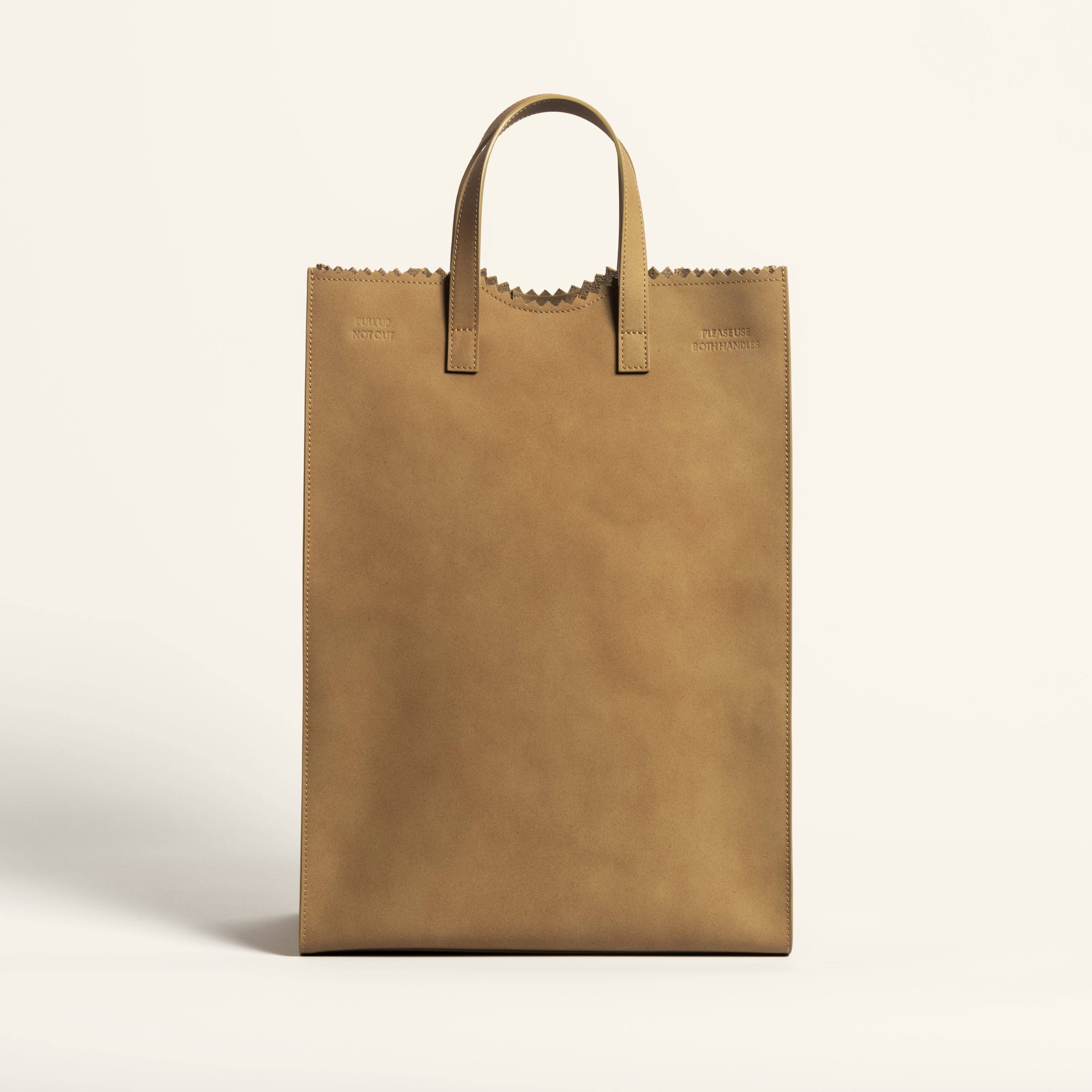 Kami tote bag by bukuro. A leather paper grocery bag front view on white backdrop.