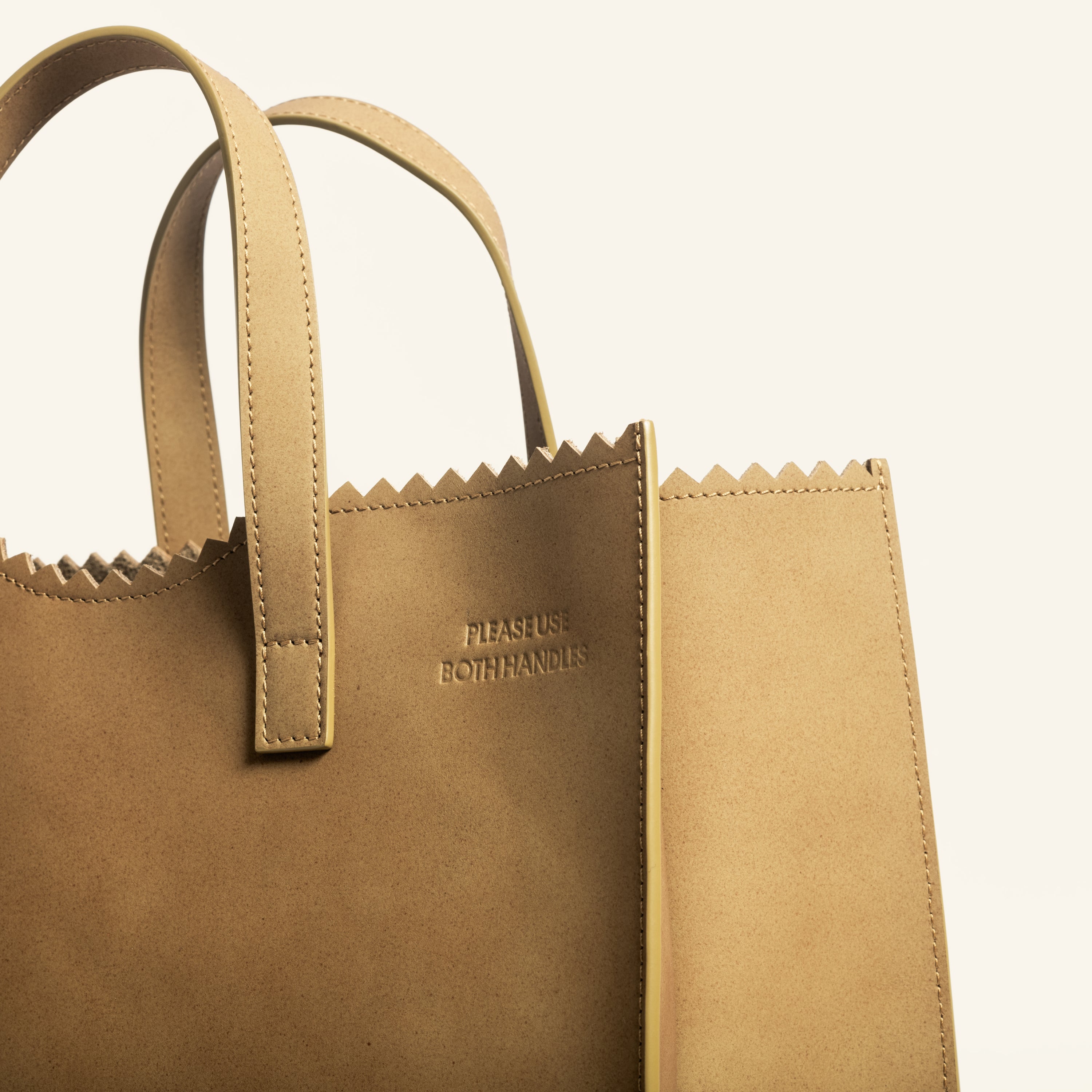 Kami tote bag by bukuro. A leather paper grocery bag detail on white backdrop.