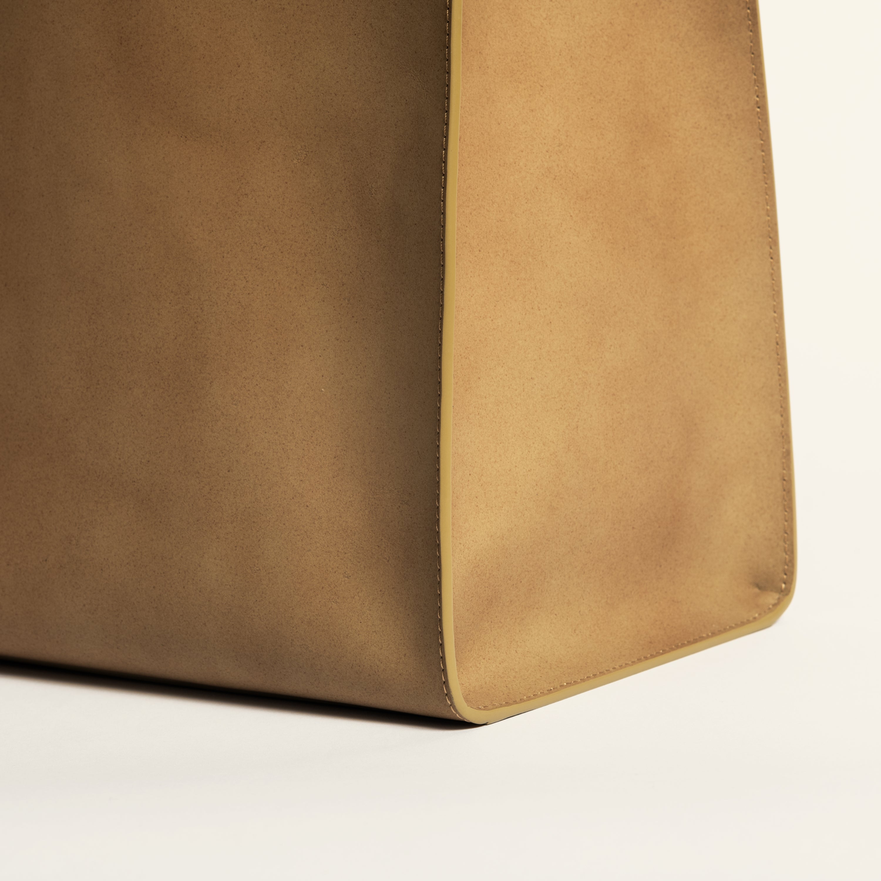 Kami tote bag by bukuro. A leather paper grocery bag detail on white backdrop.